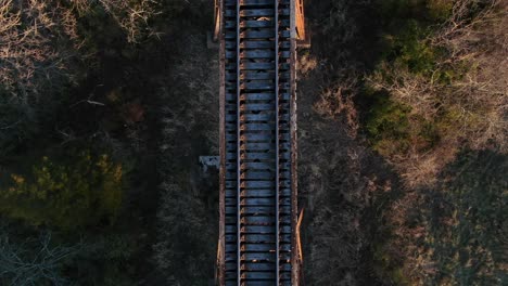 Aerial-Top-Down-Shot-Moving-Along-the-Tracks-of-the-Pope-Lick-Railroad-Trestle-in-Louisville-Kentucky-at-Sunset