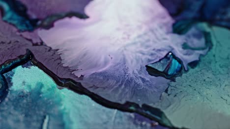 Close-up-of-vibrant-ink-diffusing-in-water,-with-a-dynamic-mix-of-purple-and-blue-hues-creating-an-abstract-art-effect