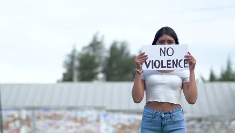 Latin-American-Woman-holding-No-violence-sign,-protest-against-war-in-Ecuador