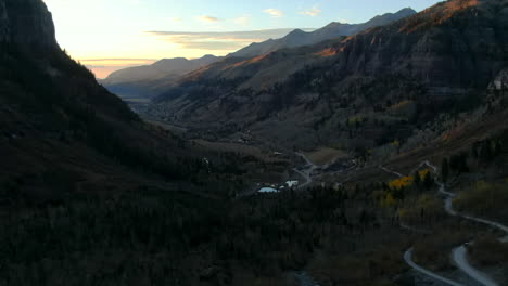 Telluride-Colorado-aerial-drone-towards-Rocky-Mountain-historic-town-scenic-landscape-autumn-golden-yellow-Aspen-trees-stunning-sunset-Silverton-Ouray-Millon-Dollar-Highway-slowly-backward-reveal-up