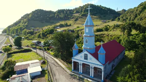 Drone-shot-around-the-UNESCO-protected-Church-of-Tenaún-in-sunny-Chiloé,-Chile