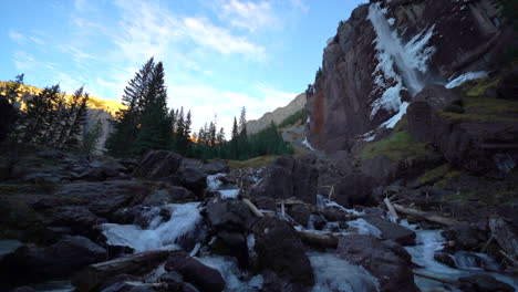 Telluride-Colorado-sunset-stream-Bridal-Veil-Falls-frozen-ice-Waterfall-fall-autumn-sunset-cool-shaded-Rocky-Mountains-Silverton-Ouray-Millon-Dollar-Highway-historic-town-scenic-landscape-slow-pan-up