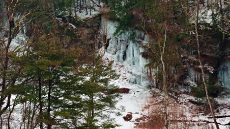 Video-of-icicles-dangling-off-of-a-cliff-in-a-snowy,-frozen-gorge