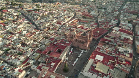 Stunning-drone-footage-showcasing-a-half-orbit-around-the-iconic-Cathedral-and-Plaza-de-Armas-in-Zacatecas,-capturing-the-essence-of-this-historic-city-from-the-sky