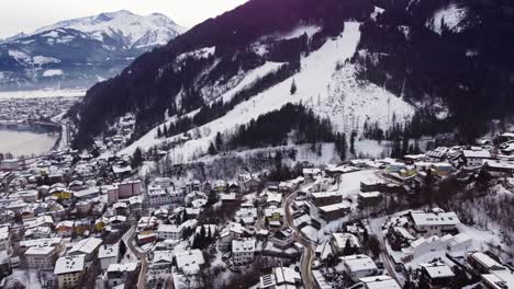Aerial-view-of-Zell-am-See-village,-Austria-winter-scenery,-dolly-in,-day