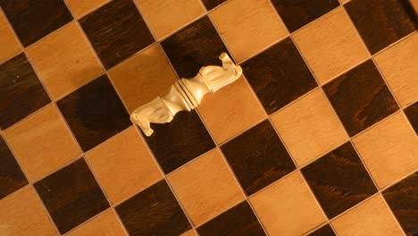 White-knights-from-chess-set,-losing-a-strategic-game-of-chess