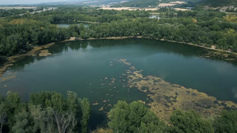Aerial-shot-of-lake-being-polluted-by-algae,-Europe