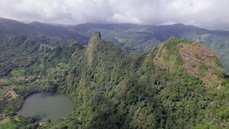 San-carlos-with-lush-greenery,-a-volcanic-crater-lake,-and-mountain-ridges,-aerial-view