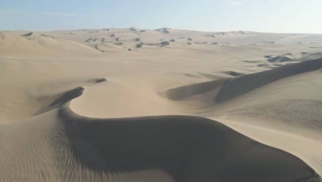 Soaring-over-the-captivating-dunes,-the-drone-unveils-the-hidden-charm-near-Huacachina