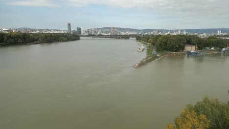 Wide-panoramic-Aerial-shot-of-Bratislava-City,-flying-over-Danube-river