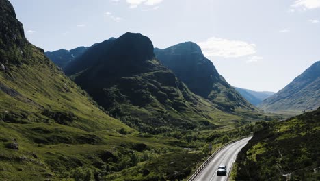 Cars-passing-through-Scotland's-Glencoe-Valley-on-a-sunny-day