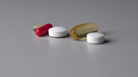Rack-focus-of-different-color-and-shape-pills-and-capsules-on-table-surface