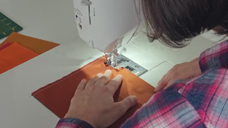 Patchwork-quilt-creation-process---sewing-on-the-sewing-machine---from-behind