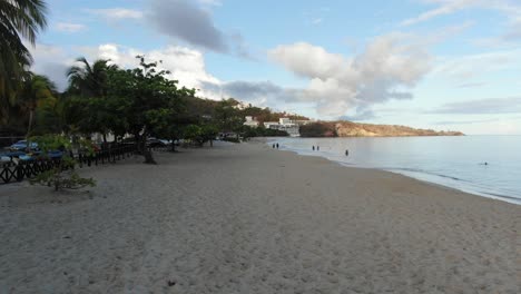 People-walking-on-tropical-beach-on-Caribbean-island,-Grenada