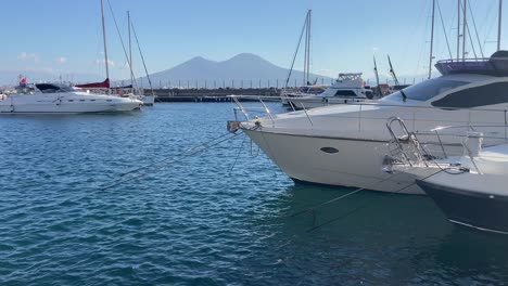 Yachts-in-the-marina-of-Naples-port-with-Mount-Vesuvius-behind