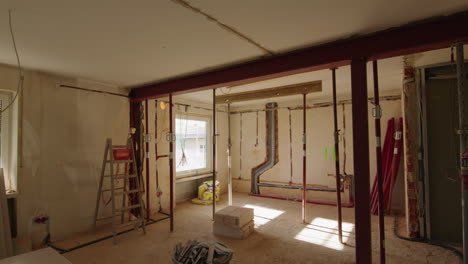 Wide-shot-of-a-construction-site,-a-lot-of-pillars-in-the-room-supporting-the-ceiling,-new-steel-beam-installed