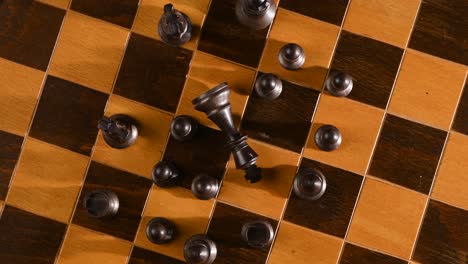 Game-of-chess,-beaten-king-on-chessboard