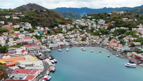 Panoramic-aerial-establishing-of-turquoise-blue-water-in-port-cove-inlet-of-colorful-Carenage-Grenada