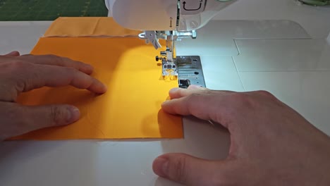 Patchwork-quilt-creation-process---sewing-on-the-sewing-machine---point-of-view