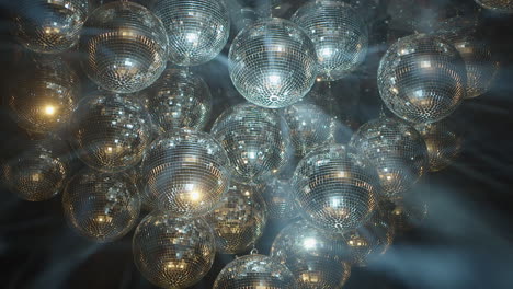 Bright-spinning-mirror-balls-sparkle-light-beams-in-black-background