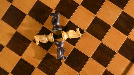 Chess-knights-knocked-down-on-chessboard