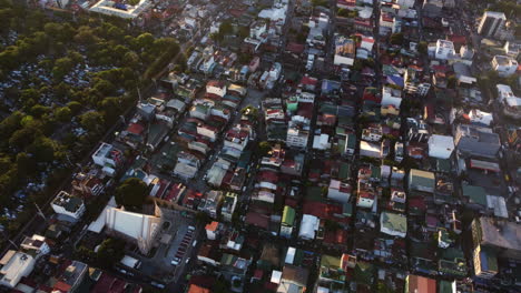 Aerial-view-over-the-Olympia-neighborhood-in-Makati-city,-sunset-in-Manila,-Philippines
