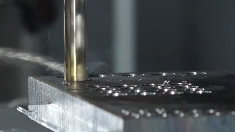CNC-drilling-machine-drill-holes-into-metal-surface-,-close-up