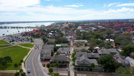 Aerial,-4k-Shot-flying-over-Saint-George-Street-in-St-Augustine,-Florida-with-people-shopping,-eating-and-drinking-at-restaurants-and-bars-on-a-beautiful-day-in-January-2024