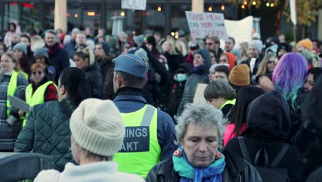 Diverse-crowd-at-women's-rights-rally-in-Stockholm-with-activist-Linnea-Claeson,-day