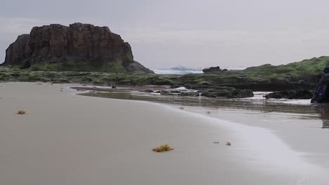 Beautiful-cinematic-sandy-beach-scene-with-sea-rocks-and-islet-in-Porto-Santo-island-in-Portugal-50fps-HD-static-shot