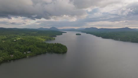 Panoramic-Aerial-View-Of-Serene-Waterbody-Surrounded-By-Lush-Green-Forest-In-Quebec,-Canada