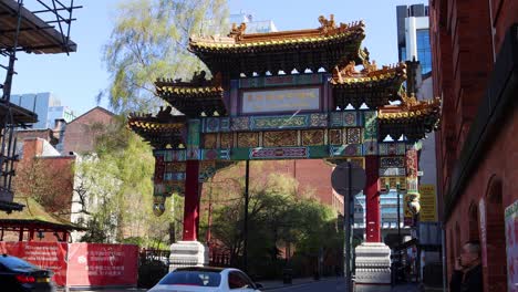 Ornate-Chinese-archway-with-trees-in-background-in-Manchester's-Chinatown,-clear-day