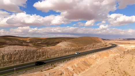 Car-heading-south-on-a-Desert-highway-with-cloudy-blue-sky