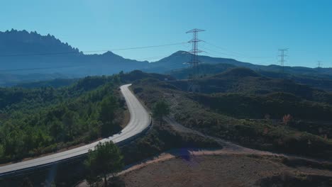 Electricity-towers-and-montserrat-in-forest-of-crosses