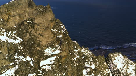 Drohnenschuss-Umkreist-Einen-Felsigen-Bergrücken,-Goldene-Stunde-An-Der-Küste-Islands