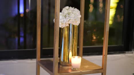 Hochzeitsdekoration-Mit-Goldener-Vase-Und-Hortensienblüten-Mit-Brennenden-Kerzen