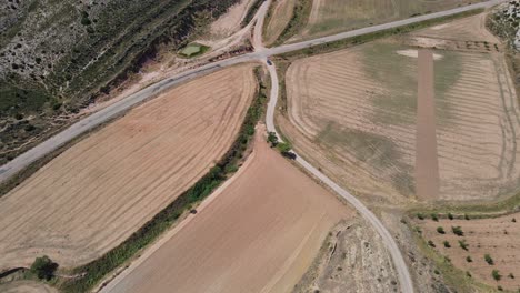 Drone-view-on-car-traveling-through-countryside-of-Spain-in-Teruel