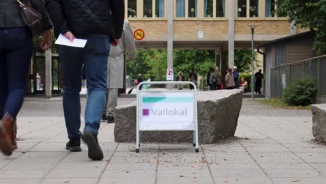 Voters-approach-polling-station-in-Stockholm,-Sweden,-during-an-election,-timelapse