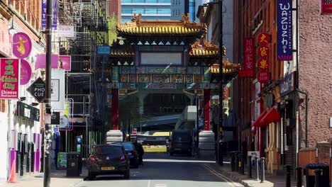 Vibrant-Chinatown-gate-in-Manchester,-UK-with-pedestrians-and-urban-setting,-daytime,-sunny