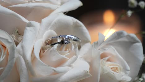 Two-white-gold-wedding-rings-among-the-white-rose-petals-of-the-bride's-bouquet