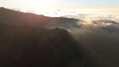 Aerial-sunrise-view-over-clouds-on-Ligurian-mountain,-Italy,-warm-tones