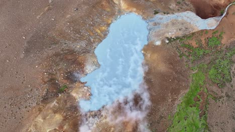An-aerial-drone's-ascending-view-from-Engjahver's-steam-lake-on-the-Reykjanes-Peninsula-in-Iceland