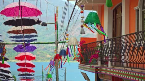Colourful-decorations,-umbrellas-and-baskets-hanging-above-a-market-street-in-San-Juan,-Lake-Atitlan,-Guatemala