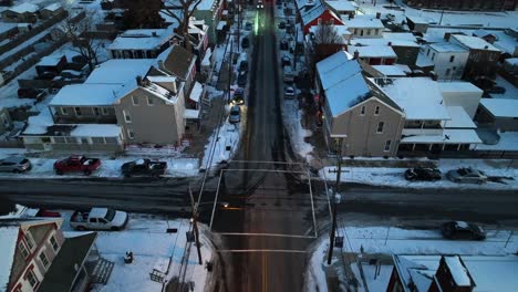 Birds-eye-flight-over-Straight-road-in-american-city-after-snow-in-winter
