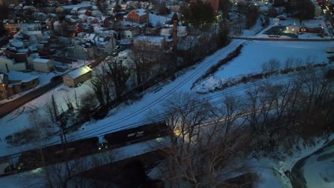 Cargo-train-on-snowy-track-in-winter-dusk