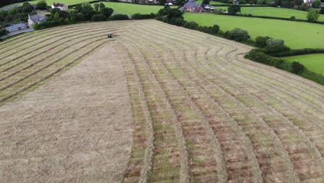 Aerial-Flying-Over-Farmland-Being-Harvested-For-Hay-In-East-Devon