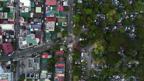 Top-down-drone-shot-above-traffic-on-the-South-Ave-street,-in-Makati,-Philippines
