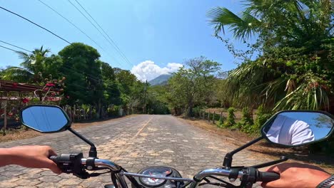 A-Man's-POV-riding-a-motorbike-towards-a-volcano