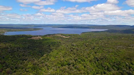 Panoramic-bird's-eye-view-of-huillinco-lake-and-the-green-forest-of-tepuhueico-park-in-Chiloé,-southern-Chile