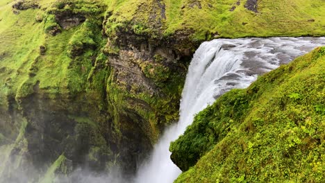 Powerful-Skogafoss-waterfall-falling-in-gorge,-Iceland,-high-angle-view